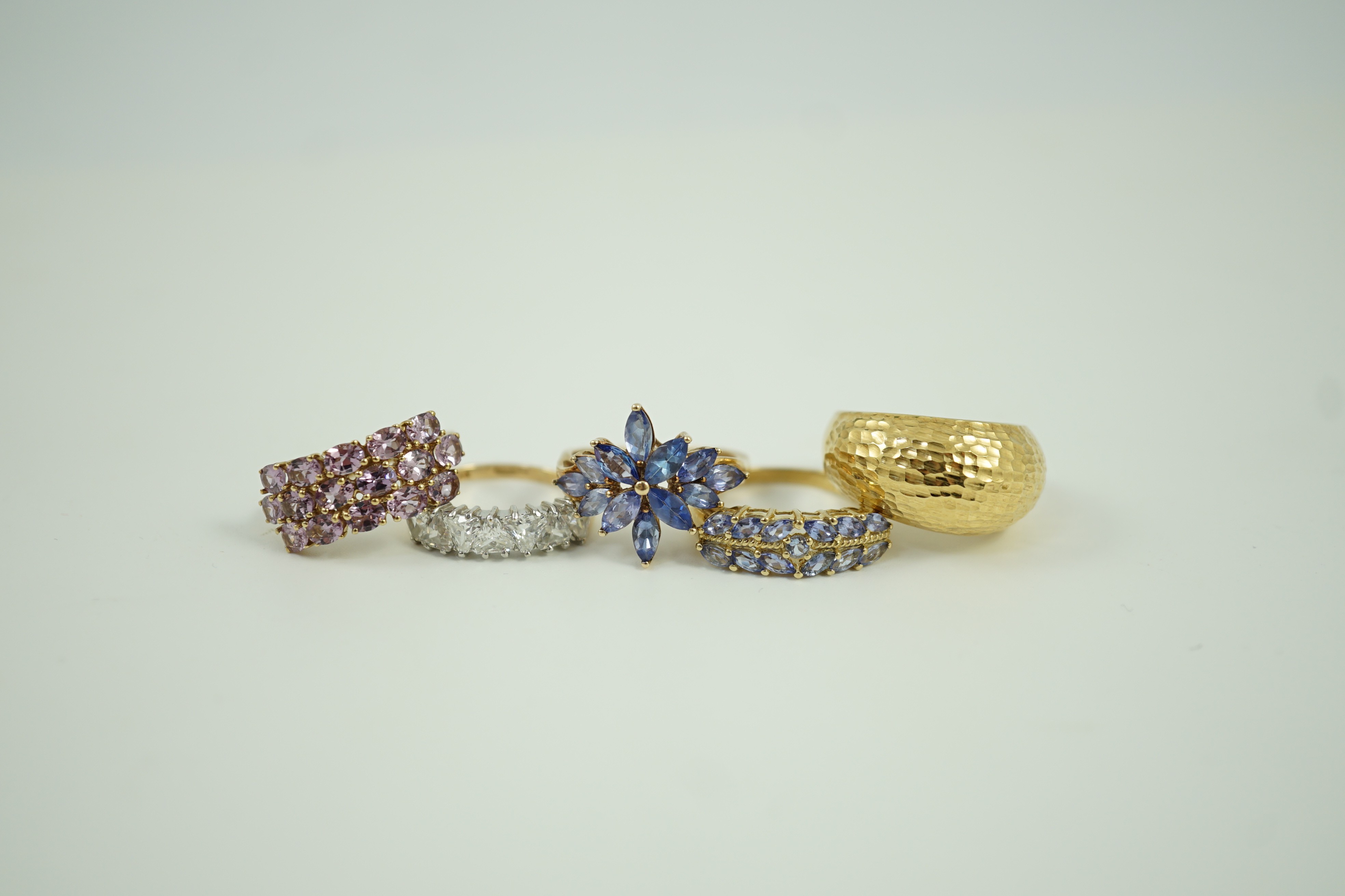 Four assorted modern 9ct gold and gem set rings and an Italian 375 ring, gross weight 14.4 grams.